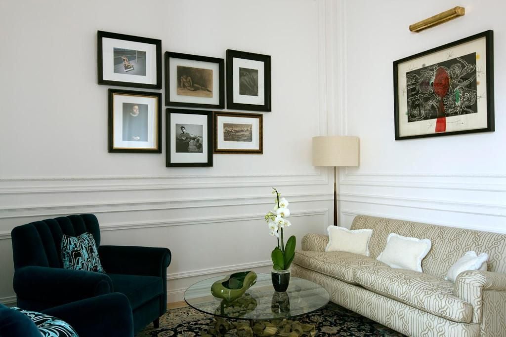 Elegant executive suite at Palazzo Dama with plush king bed, marble-clad bathroom, and expansive city view through large floor-to-ceiling windows in Rome, Italy