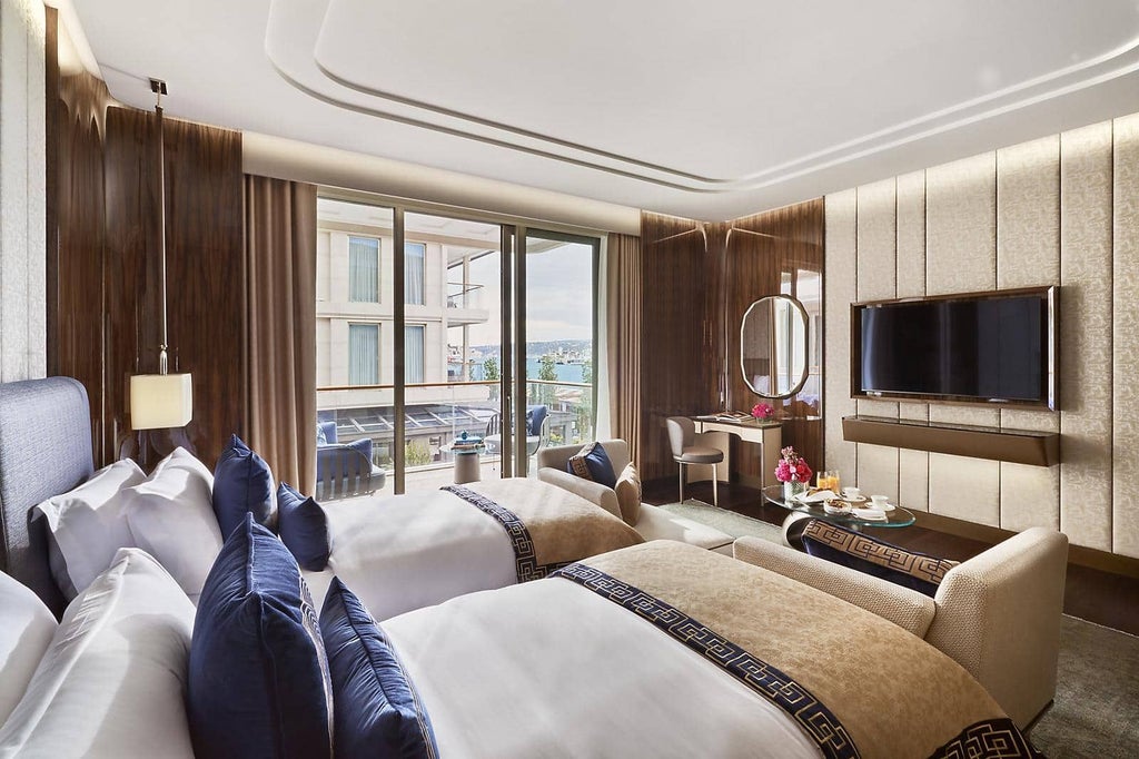 Luxurious deluxe room at Mandarin Oriental Bosphorus with stunning water views, elegant modern decor, and plush king bed overlooking Istanbul's scenic waterfront