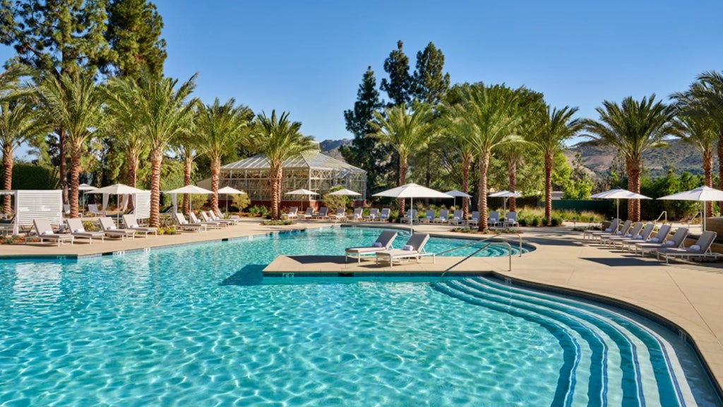 Luxurious Four Seasons resort nestled in Westlake Village, California, with elegant architecture, lush landscaping, and a serene water feature