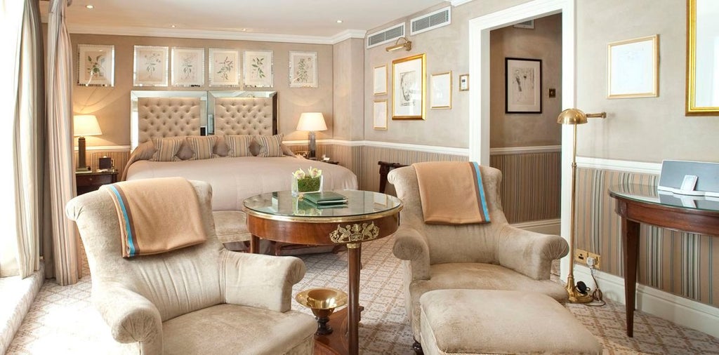 Elegant royal suite with plush cream furnishings, ornate chandelier, and classic British design overlooking a refined interior at scenset Milestone Hotel in Kensington, London