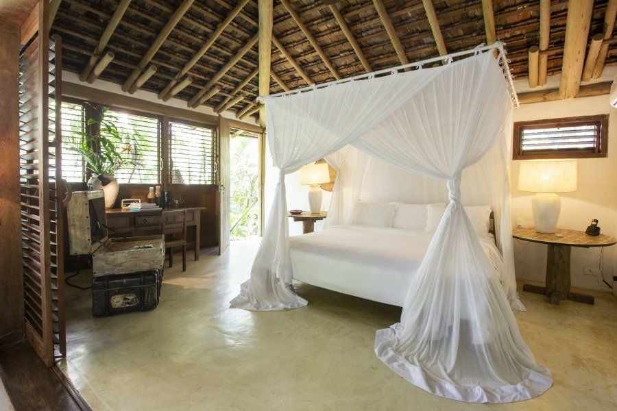 Rustic-chic wooden interior of luxurious Brazilian hotel room with elegant tropical decor, natural light, and traditional Bahian architectural elements