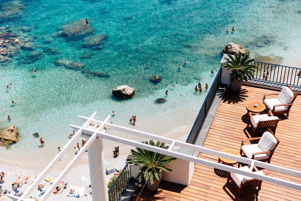 Elegant cliffside luxury hotel in Capri with white Mediterranean architecture, panoramic sea views and manicured garden terraces