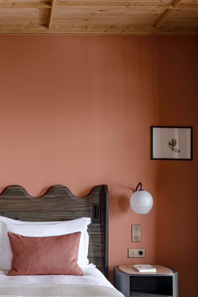 Luxurious prestige room at Le Coucou Méribel, featuring contemporary alpine design with elegant wood accents and mountain-view window