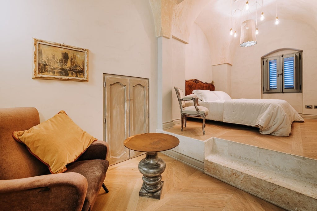 Elegant Deluxe Room with ornate vintage furnishings, high ceilings, warm neutral color palette, and plush king-sized bed in historic Italian boutique hotel