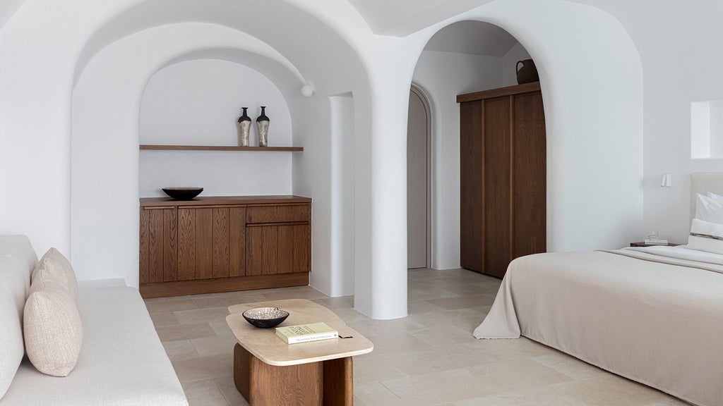 Luxurious white-washed Honeymoon Suite at Canaves, Santorini, with private infinity pool overlooking azure Aegean Sea and minimalist elegant design