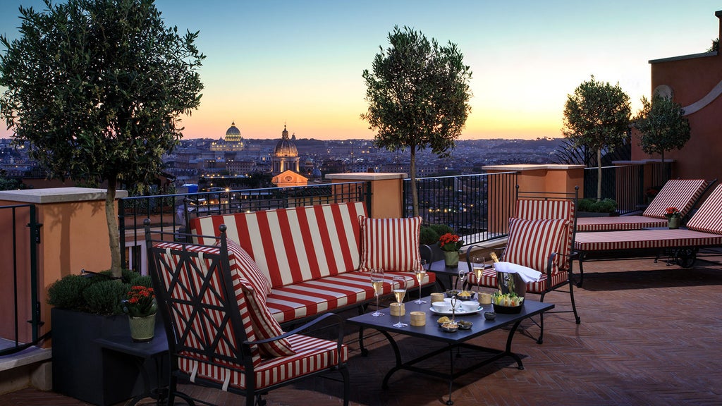 Elegant five-star Hotel de la Ville in Rome features ornate baroque architecture with grand balconies overlooking historic city streets