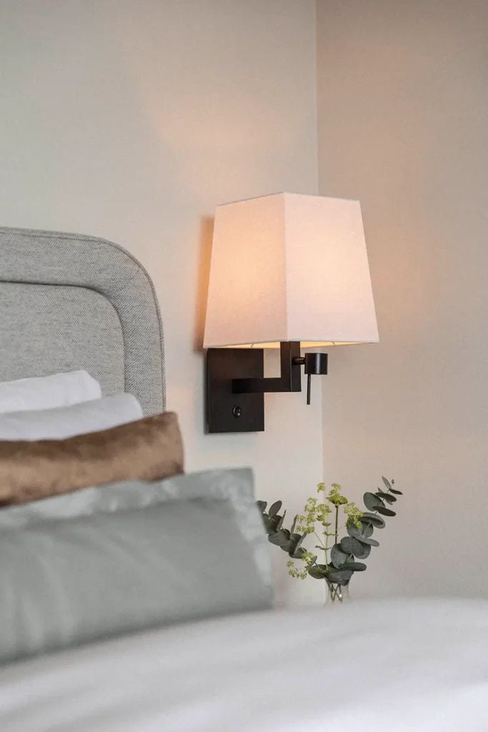 Elegant Deluxe Signature room at scenic Swedish hotel, featuring plush king bed, modern minimalist decor, soft neutral tones, and large designer windows