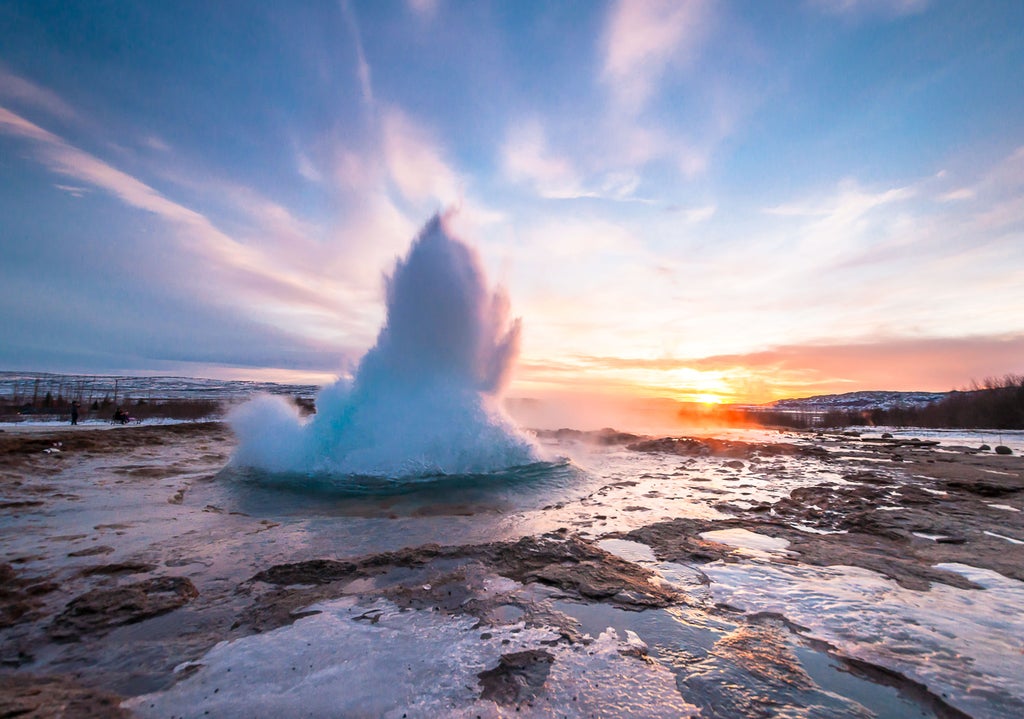 Golden Circle scenic landscape with cascading Gullfoss waterfall, steaming Geysir hot spring, and rugged Þingvellir National Park under dramatic Icelandic sky