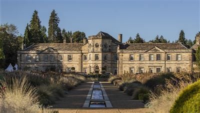 Luxurious five-star hotel nestled in scenic Yorkshire countryside, featuring elegant stone exterior, manicured gardens, and grand architectural design of Scenset Hall.