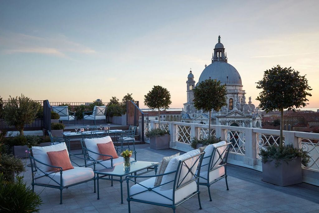 St Regis Venice hotel facade with ornate renaissance architecture overlooking Grand Canal, featuring marble balconies and classic columns