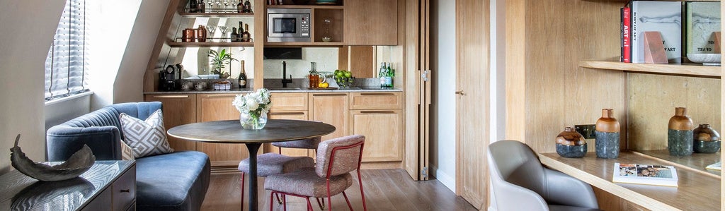 Luxurious loft suite with modern minimalist design, featuring expansive windows, neutral color palette, and elegant contemporary furnishings in The Scenset hotel