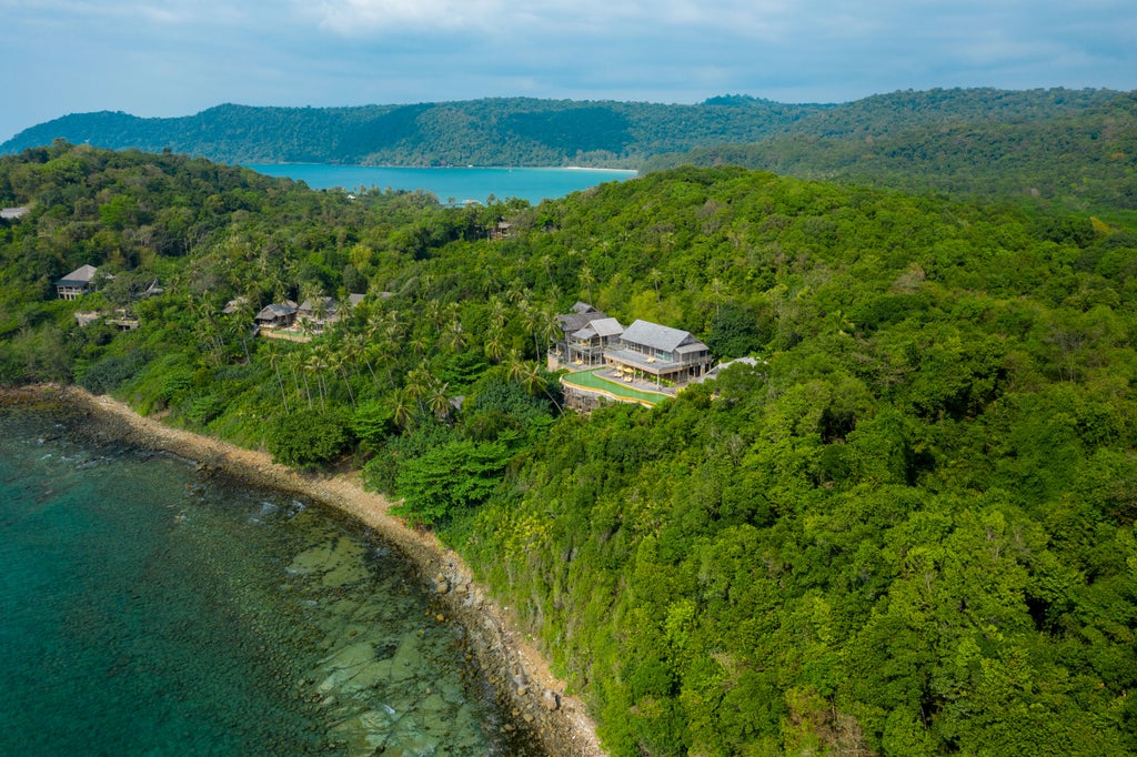 Luxurious overwater villa with private infinity pool overlooking pristine turquoise waters and lush jungle at Soneva Kiri resort, Thailand