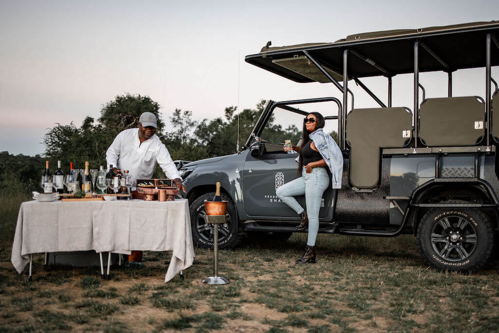 Elegant luxury train hotel suspended over Sabie River in Kruger Park, featuring glass-walled suites with panoramic savanna views