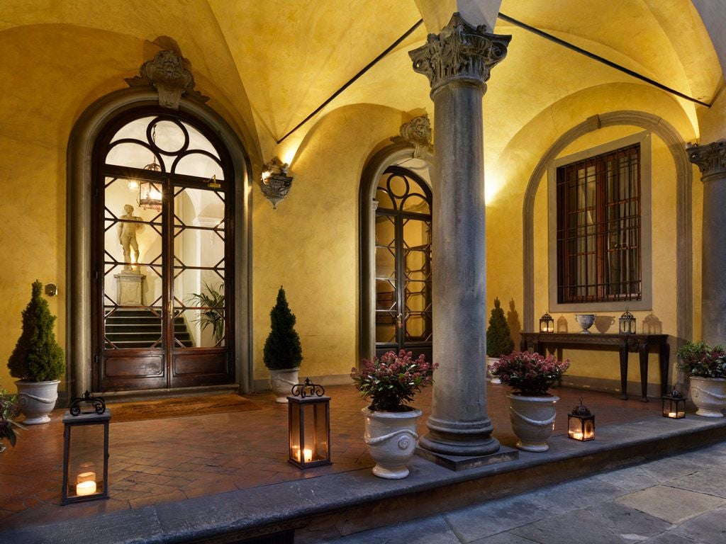 Elegant 16th-century Palazzo di Camugliano in Florence, with frescoed ceilings, antique furnishings, and a grand marble staircase in warm Tuscan light