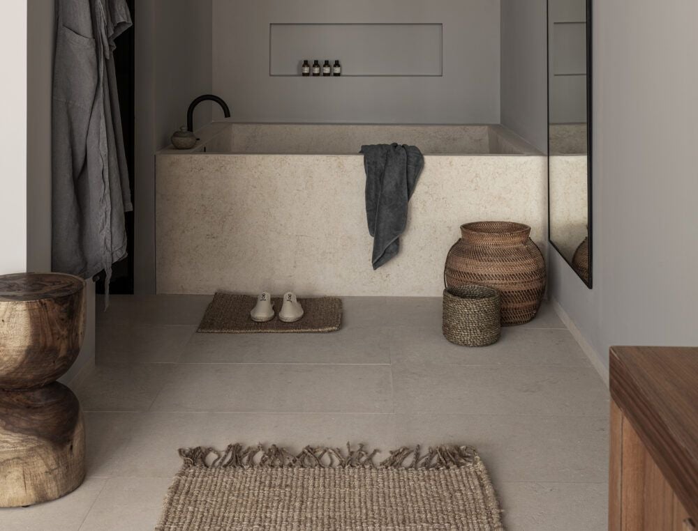 Minimalist white and wood design Deluxe Junior Suite at OKU Ibiza, showcasing elegant bed, natural light, and contemporary Mediterranean coastal styling