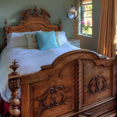 Elegant Venetian-style hotel room with plush king bed, ornate gold-framed mirror, luxurious cream and burgundy color palette, soft ambient lighting