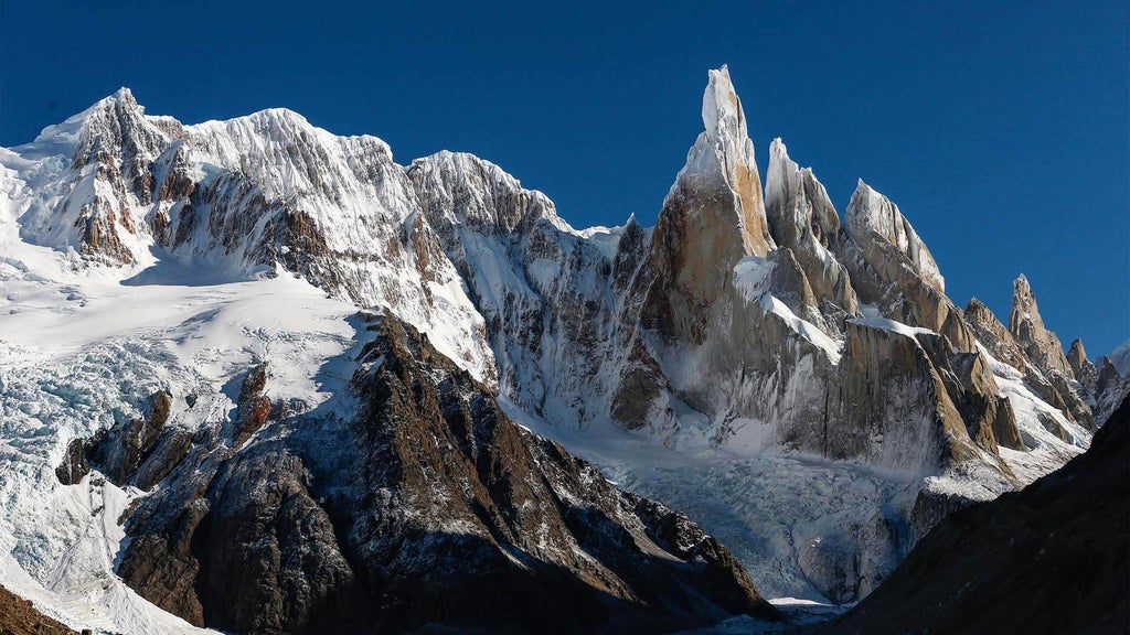 Luxurious mountain view from boutique hotel balcony, showcasing rustic-chic architecture with elegant wood accents and panoramic Andean landscape in Argentina