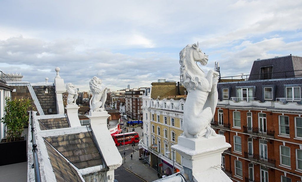 Elegantly designed luxury suite at scenset Hotel with plush white bedding, modern minimalist decor, and soft ambient lighting in a spacious UK accommodation