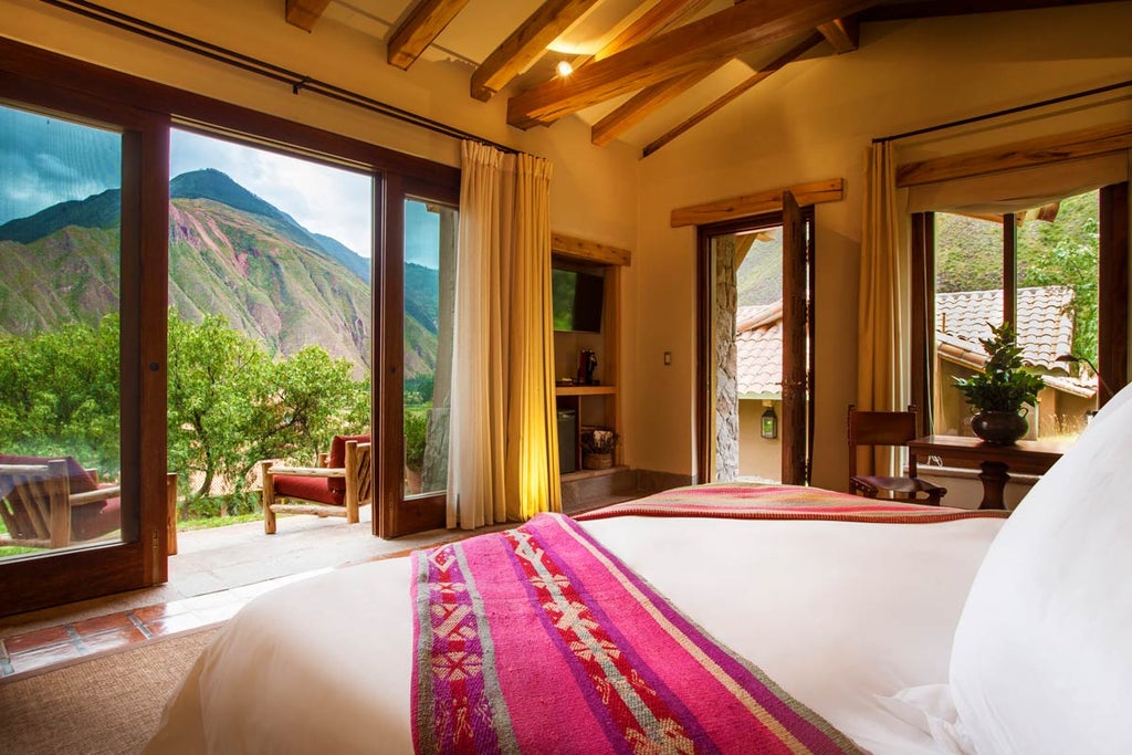 Luxurious mountain lodge with stone facade nestled in Peru's Sacred Valley, featuring panoramic Andes views and manicured gardens