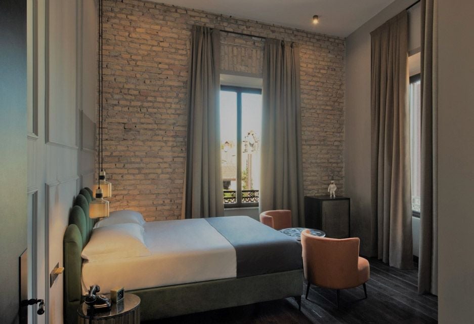 Luxurious baby double hotel room at Chapter Roma with soft neutral tones, plush bedding, minimalist design, and warm ambient lighting in a contemporary Italian style.