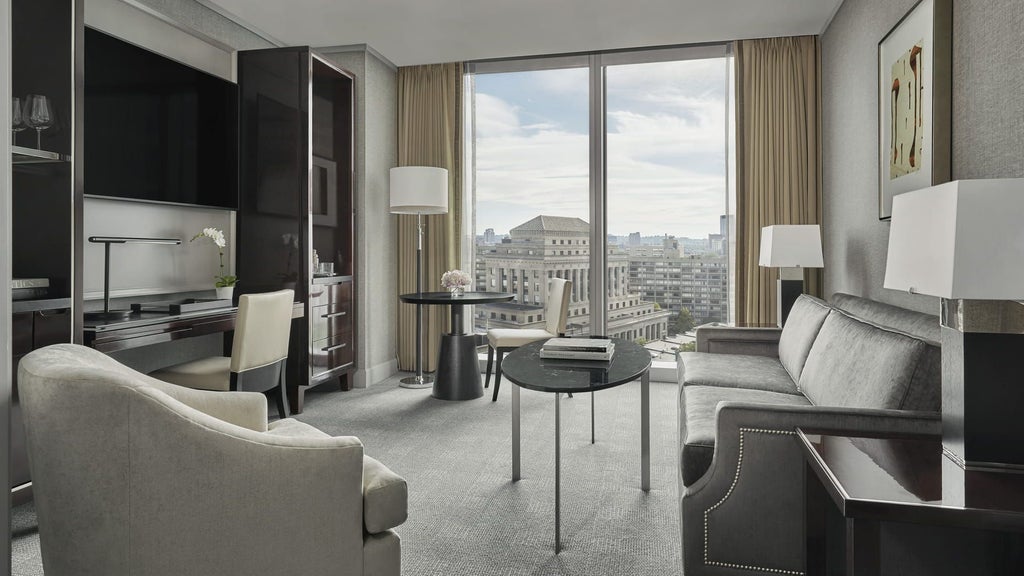 Luxurious glass and steel exterior of a modern high-rise hotel with sleek architectural design overlooking Boston's urban skyline at twilight