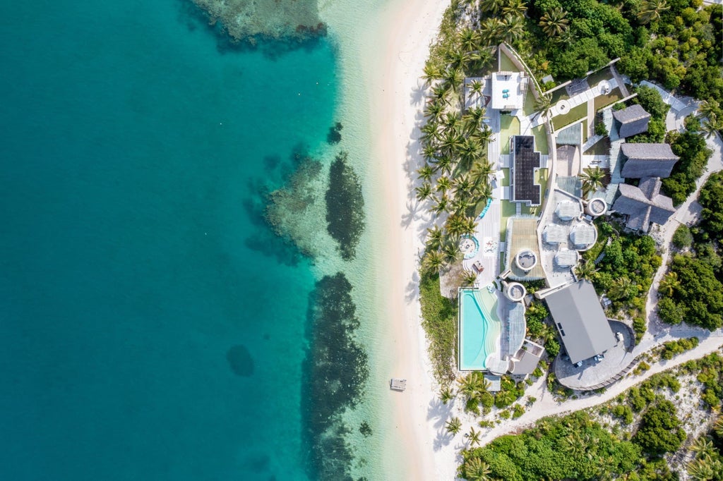 Luxurious oceanfront villa with private pool overlooking pristine white beach and turquoise waters on Madagascar's remote coastline