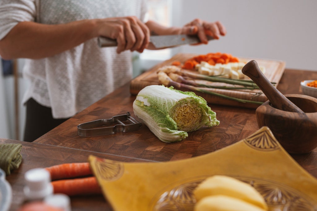 Traditional Portuguese kitchen scene with fresh ingredients, copper pots, vibrant vegetables, and a chef demonstrating authentic cooking techniques during a gourmet culinary workshop in Lisbon