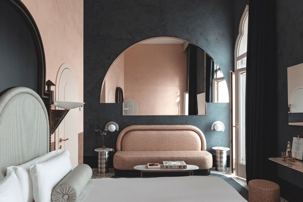 Luxurious Venetian hotel room with private balcony overlooking canal, featuring elegant decor and expansive water views of historic Giudecca island