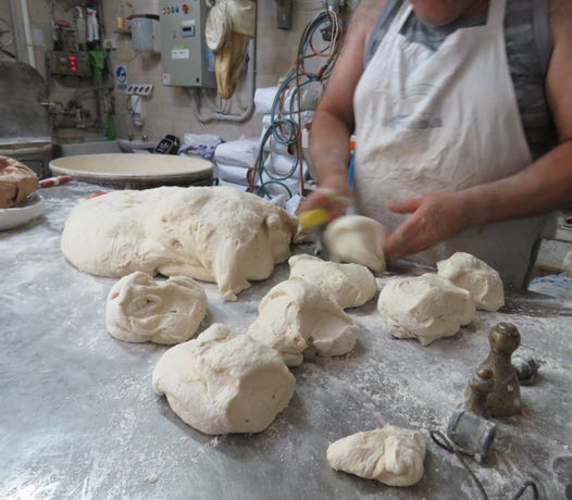 Kneading dough by hand in a local bakery