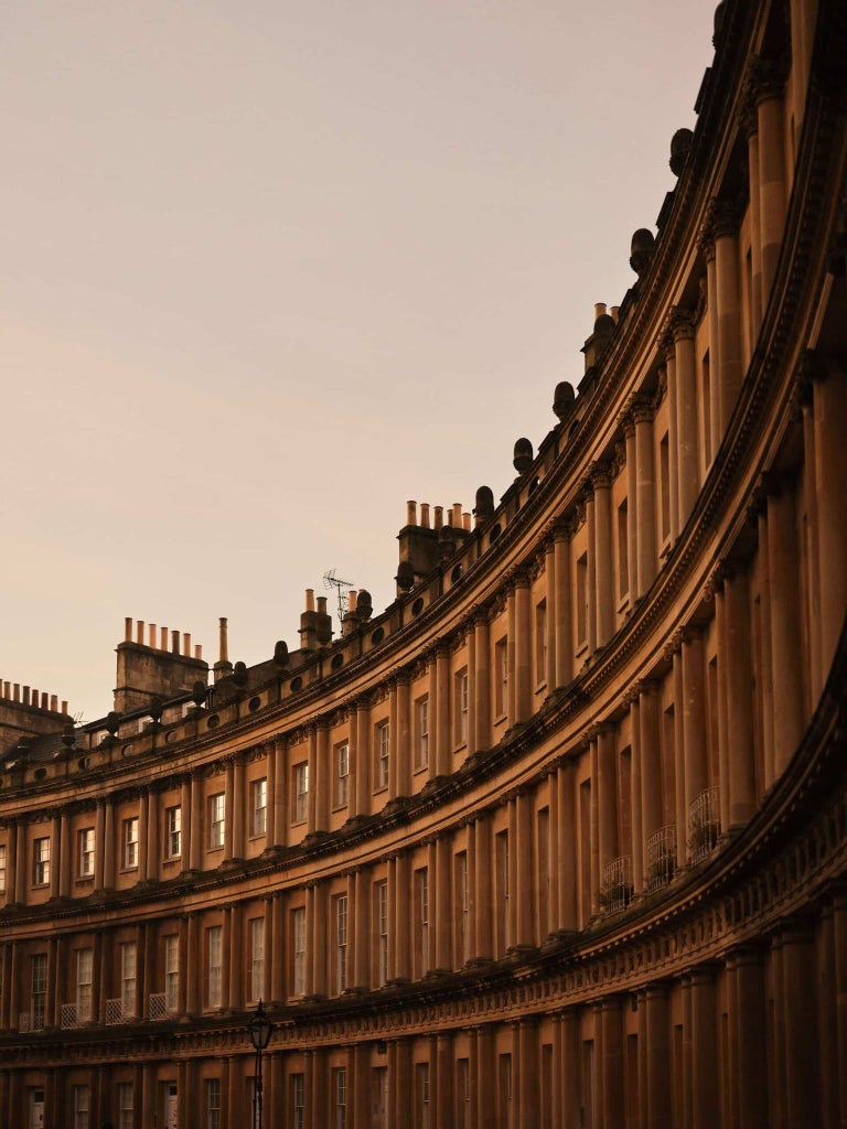 Elegant Georgian-style luxury hotel exterior with classical architecture, warm stone facade, and pristine windows in a historic United Kingdom setting