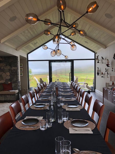 Elegantly plated Nordic cuisine served on rustic wooden table in cozy farm-to-table dining room with warm ambient lighting