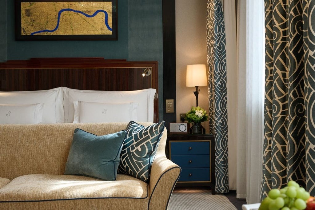 Elegant classic room with plush king bed, refined wood furnishings, soft neutral palette, and luxurious white linens at prestigious Mayfair hotel