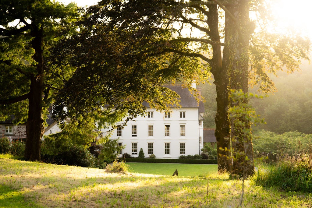 Elegant country house hotel nestled in lush Welsh countryside, with stone facade, manicured gardens, and sophisticated architectural details showcasing refined luxury