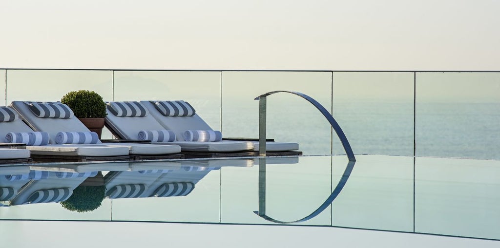 Modern luxury beachfront hotel in Rio with Art Deco facade, infinity pool terrace overlooking Ipanema Beach and Atlantic Ocean