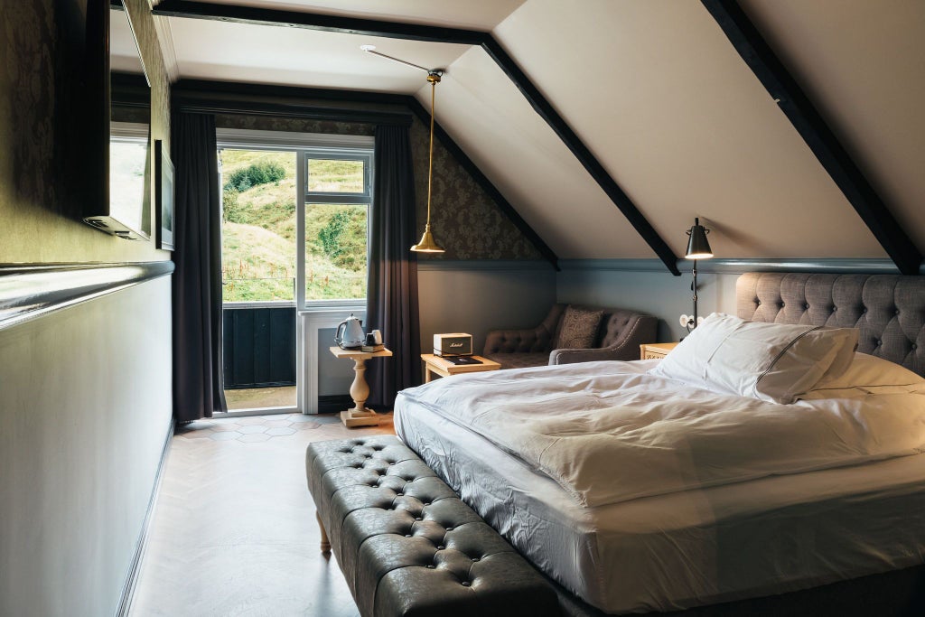 Cozy Icelandic single hotel room with elegant wooden furnishings, soft neutral colors, and minimalist Nordic design showcasing comfort and serenity