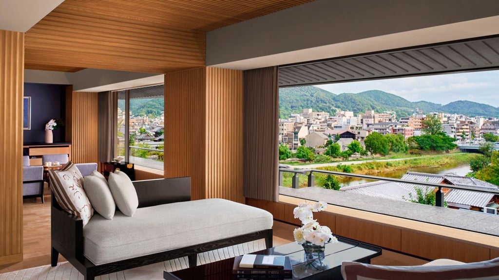 Luxurious riverside hotel with traditional Japanese architecture, nestled against Kyoto's scenic mountains and elegant garden landscape at golden hour