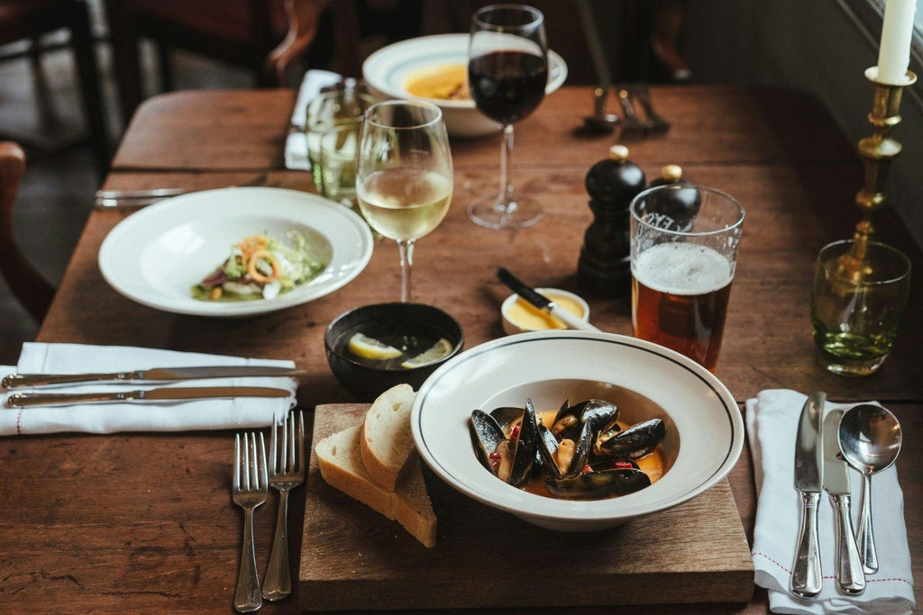 Charming stone-built country pub with traditional facade, rustic windows, and warm lighting, nestled in a picturesque United Kingdom countryside setting