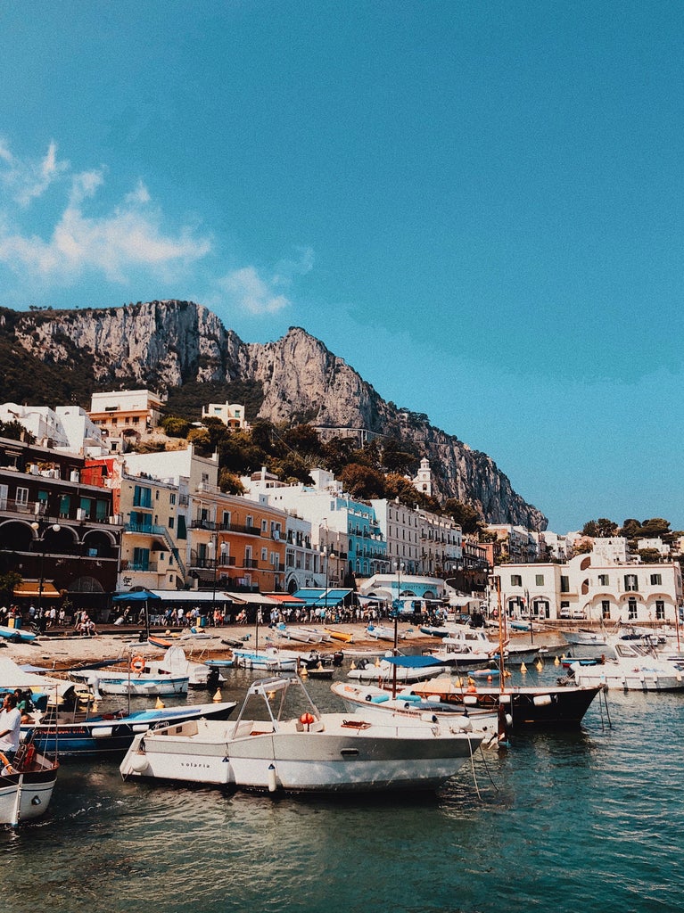 Luxury villa perched on Capri's cliffside with panoramic Mediterranean views, featuring elegant white architecture and lush gardens