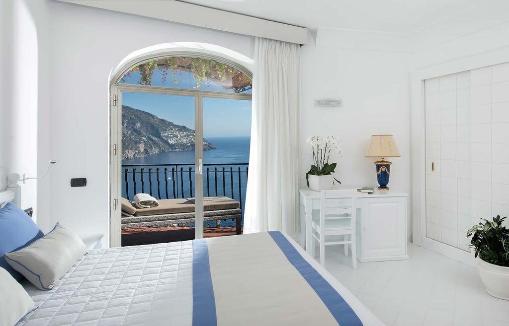 Luxury cliffside hotel Le Agavi in Positano with cascading white balconies, infinity pools, and panoramic views of the Amalfi coast