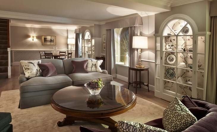 Luxurious Coach House Suite at Chewton Glen Spa, featuring elegant modern design with plush king bed, contemporary furnishings, and soft natural lighting