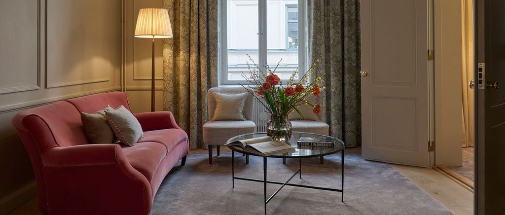 Elegant Swedish hotel room with plush white bedding, warm wooden furnishings, soft neutral tones, and minimalist Nordic design aesthetic