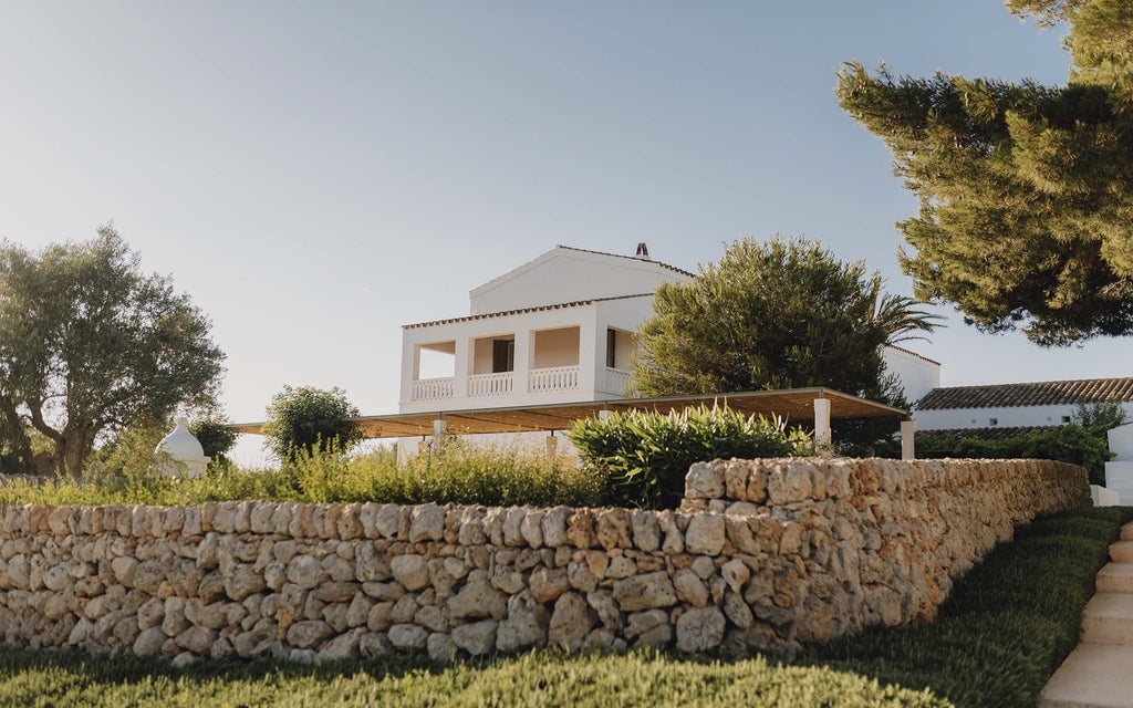 Luxurious white-walled hotel room with panoramic sea view, minimalist design, crisp linens, and elegant contemporary Mediterranean style furniture