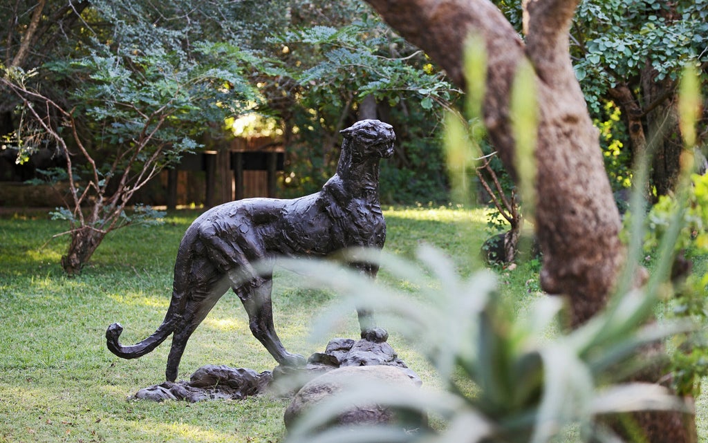 Luxury safari lodge with private deck overlooking African savanna, featuring plunge pool and elegant outdoor lounge furniture