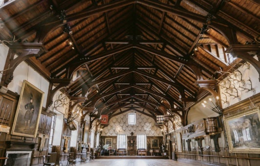 Majestic Blair Castle in Scottish Highlands, gray stone walls with turrets, lush green landscape, elegant architecture showcasing Scottish heritage and historic grandeur