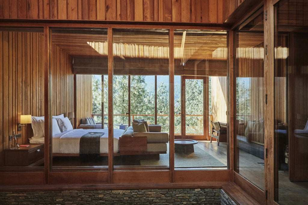 A luxurious mountain lodge with floor-to-ceiling windows nestled in a pine forest, featuring natural wood architecture and modern design