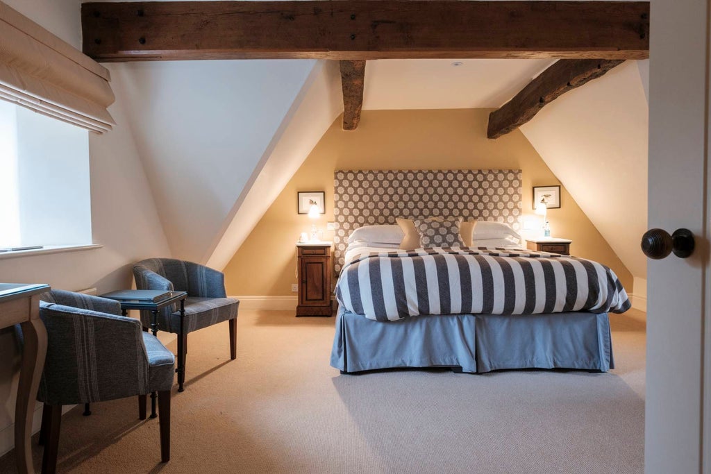 Elegant classic double room at The Close Hotel, featuring plush white bedding, warm wooden furnishings, and soft neutral color palette in a refined UK setting