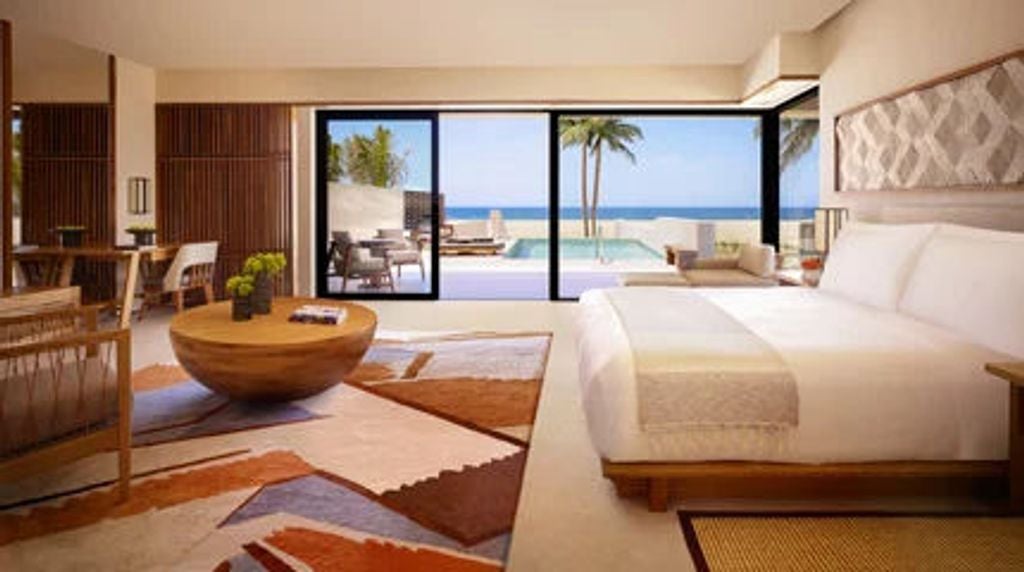 Modern luxury suite with oceanfront balcony, private infinity pool, king bed, contemporary Japanese design, and floor-to-ceiling windows