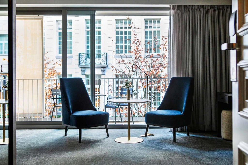 Elegant white-draped luxury hotel room with plush king-sized bed, soft Belgian linens, modern minimalist decor, and sophisticated neutral color palette