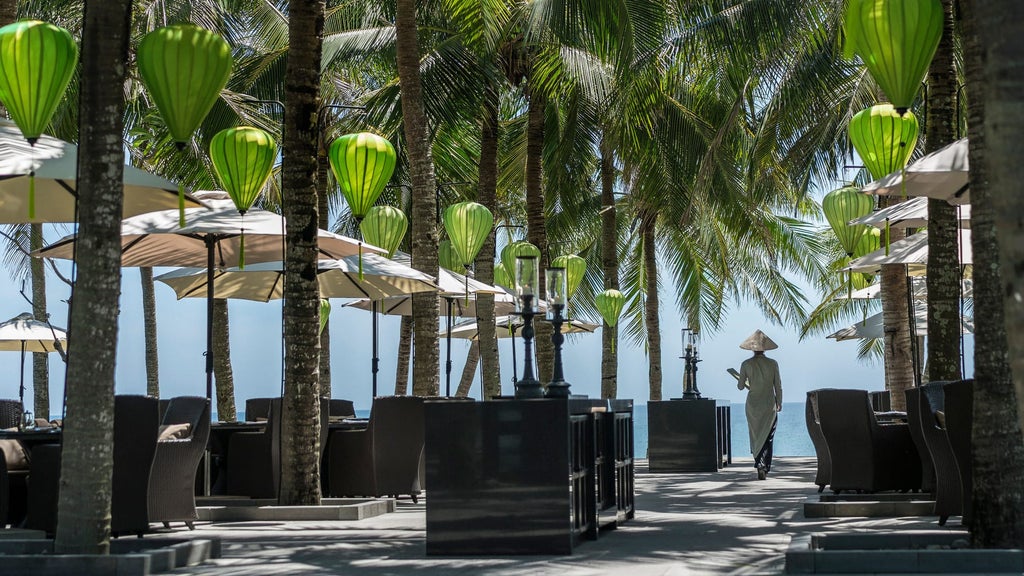 Elegant beachfront villa at Four Seasons Nam Hai with infinity pool overlooking pristine white sand beach and turquoise South China Sea