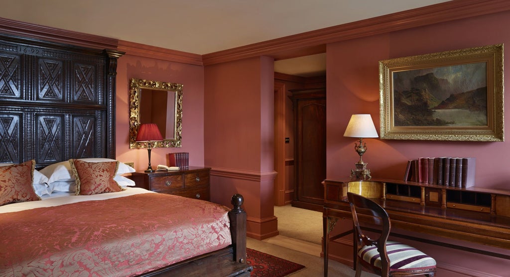 Opulent Georgian-style bedroom with ornate four-poster bed, rich velvet furnishings, and intricate period details at Batty Langley's luxury boutique hotel in United Kingdom